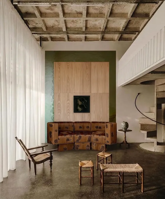 A serene interior scene featuring a modern living space with minimalist furniture and art. The colour palette includes warm wood tones and earthy greens, highlighting a combination of natural materials and textures.
